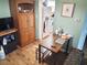 Cozy living area featuring hardwood floors, a wooden cabinet, and an open layout to the kitchen at 100 Waverly Way # 302, Clearwater, FL 33756