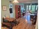 Spacious living room boasts hardwood floors, natural light, and an open layout to a side den at 100 Waverly Way # 302, Clearwater, FL 33756
