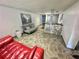 Comfortable lobby provides inviting red couch, gray sofa, contemporary design, and unique stone decor at 100 Waverly Way # 302, Clearwater, FL 33756