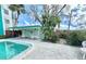 Poolside cabana with tables, chairs, and a pool rules sign, overlooking a sparkling community pool at 100 Waverly Way # 302, Clearwater, FL 33756