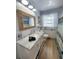 Updated bathroom featuring a marble countertop vanity, updated fixtures, and a decorative framed mirror at 12361 114Th St, Largo, FL 33778