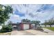 Charming single-story home featuring a brick facade, carport, and well-maintained landscaping at 12361 114Th St, Largo, FL 33778