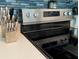 Close-up of sleek stovetop with modern cook wear, complemented by beautiful backsplash at 12361 114Th St, Largo, FL 33778