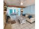 Bright living room with tile floors, exposed beam, stone fireplace and view into the dining area at 12361 114Th St, Largo, FL 33778