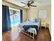 Main bedroom with an exterior sliding glass door leading to a pool, and two windows with blinds at 12361 114Th St, Largo, FL 33778
