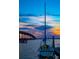 Beautiful waterfront view with a sailboat docked near a bridge during a colorful sunset at 12361 114Th St, Largo, FL 33778