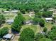 Aerial view of home surrounded by mature trees and a large green lawn at 12526 Spottswood Dr, Riverview, FL 33579