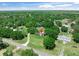 Aerial view of the property showcasing its setting amongst lush trees and quiet surroundings at 12526 Spottswood Dr, Riverview, FL 33579