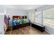 Bedroom with natural light, a reading lamp and a bed with drawer storage at 12526 Spottswood Dr, Riverview, FL 33579