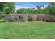 Wide exterior shot of home with a grassy lawn, gravel landscaping and a deck at 12526 Spottswood Dr, Riverview, FL 33579