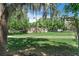 Manufactured home with an inviting exterior, surrounded by mature trees and a well-maintained lawn at 12526 Spottswood Dr, Riverview, FL 33579