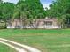 Charming home featuring a covered porch and large front yard at 12526 Spottswood Dr, Riverview, FL 33579