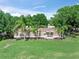 Inviting single-story home with palm trees and a manicured lawn offering a serene setting at 12526 Spottswood Dr, Riverview, FL 33579