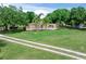 Front exterior with a spacious lawn and trees at 12526 Spottswood Dr, Riverview, FL 33579