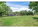 Spacious front yard view featuring a single-story home, lush green lawn, and mature trees at 12526 Spottswood Dr, Riverview, FL 33579