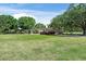 Well-maintained single-story home featuring a green lawn and mature trees in a spacious front yard at 12526 Spottswood Dr, Riverview, FL 33579