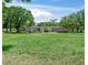 Charming single-story home with an inviting front yard featuring a green lawn and mature trees at 12526 Spottswood Dr, Riverview, FL 33579