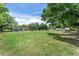 Large front yard with lush grass and a long, single-story house in a serene setting at 12526 Spottswood Dr, Riverview, FL 33579