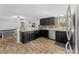Spacious kitchen features wood floors, dark cabinets, and stainless steel appliances at 12526 Spottswood Dr, Riverview, FL 33579