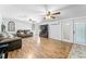 Spacious living room featuring wood-look flooring, modern ceiling fans and a double French doors at 12526 Spottswood Dr, Riverview, FL 33579