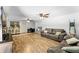 A large living area featuring wood-look flooring, ceiling fans, and comfortable seating at 12526 Spottswood Dr, Riverview, FL 33579