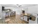 Open-concept space with wood-look floors, a breakfast bar and built in bench seating at 12526 Spottswood Dr, Riverview, FL 33579