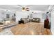 Spacious living room featuring wood-look flooring, modern ceiling fans and comfortable furniture at 12526 Spottswood Dr, Riverview, FL 33579