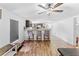 Open living area shows the kitchen, breakfast bar, and dining area with wood floors at 12526 Spottswood Dr, Riverview, FL 33579