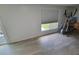 Image shows a room with wood floors, an exercise machine, and window overlooking the yard at 12526 Spottswood Dr, Riverview, FL 33579