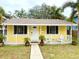 Charming yellow home with a white picket fence and lush tropical landscaping in a desirable neighborhood at 2526 44Th S St, St Petersburg, FL 33711