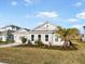 Inviting one-story home featuring a well-manicured lawn and attractive landscaping at 33843 Galley Way, Wesley Chapel, FL 33543