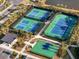 Aerial view showcases a tennis and basketball court complex with lush greenery, ideal for recreational activities at 33843 Galley Way, Wesley Chapel, FL 33543