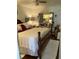 A full-size bed, side tables, mirrored vanity, hardwood floor, and ceiling fan are features of the bedroom at 4300 58Th N St # 1909, Kenneth City, FL 33709