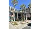 A multi-story condominium building features a beautiful entry and surrounding landscaping at 4300 58Th N St # 1909, Kenneth City, FL 33709