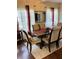 A formal dining area features hardwood floors, an area rug, and a window with decorative sheer curtains at 4300 58Th N St # 1909, Kenneth City, FL 33709