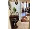 View of the home's entryway and an adjacent dining room featuring hardwood floors and natural light at 4300 58Th N St # 1909, Kenneth City, FL 33709