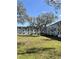 A view of the property showcasing mature trees and a well-maintained lawn at 4300 58Th N St # 1909, Kenneth City, FL 33709