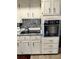 A kitchen features stainless steel appliances, white cabinets, and tiled backsplash at 4300 58Th N St # 1909, Kenneth City, FL 33709