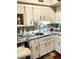 The kitchen features tiled backsplash, white cabinets, and stainless steel appliances at 4300 58Th N St # 1909, Kenneth City, FL 33709