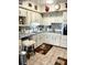 A charming kitchen boasts white cabinets, tiled backsplash, and modern appliances at 4300 58Th N St # 1909, Kenneth City, FL 33709