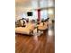A cozy living room features hardwood floors, two sofas, chairs and decorative accents at 4300 58Th N St # 1909, Kenneth City, FL 33709