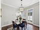 Cozy dining area with dark wood table and chairs, view of the modern kitchen at 8203 Interbay Blvd, Tampa, FL 33616