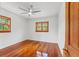 Bright bedroom with hardwood floors and windows offering a serene view of the surrounding greenery at 906 W Henry Ave, Tampa, FL 33604