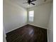 The bedroom features luxury vinyl plank flooring, a ceiling fan, and bright window at 929 Windton Oak Dr, Ruskin, FL 33570