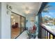 Enjoy the outdoors on your balcony with chairs and a table; peek into the living area at 11485 Oakhurst Rd # A301, Largo, FL 33774
