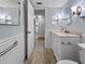 Tastefully updated bathroom with a marble countertop, modern fixtures, and a beautifully tiled floor at 11485 Oakhurst Rd # A301, Largo, FL 33774