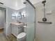 The updated bathroom features a glass shower, modern fixtures, and plenty of lighting at 11485 Oakhurst Rd # A301, Largo, FL 33774
