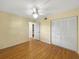 Bedroom features a ceiling fan, closet and view to kitchen area at 11485 Oakhurst Rd # A301, Largo, FL 33774
