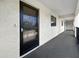 View of the hallway, with a neutral carpet leading to other front doors at 11485 Oakhurst Rd # A301, Largo, FL 33774