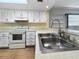 Stainless steel sink with laminate countertops and white cabinets at 11485 Oakhurst Rd # A301, Largo, FL 33774